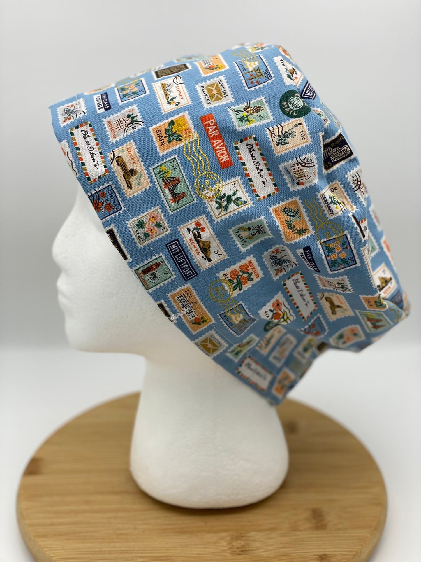 Blue postage stamp euro scrub cap, Rifle Paper Bon Voyage print women’s euro scrub cap, scrub cap stamps, Bonnet Head Designs