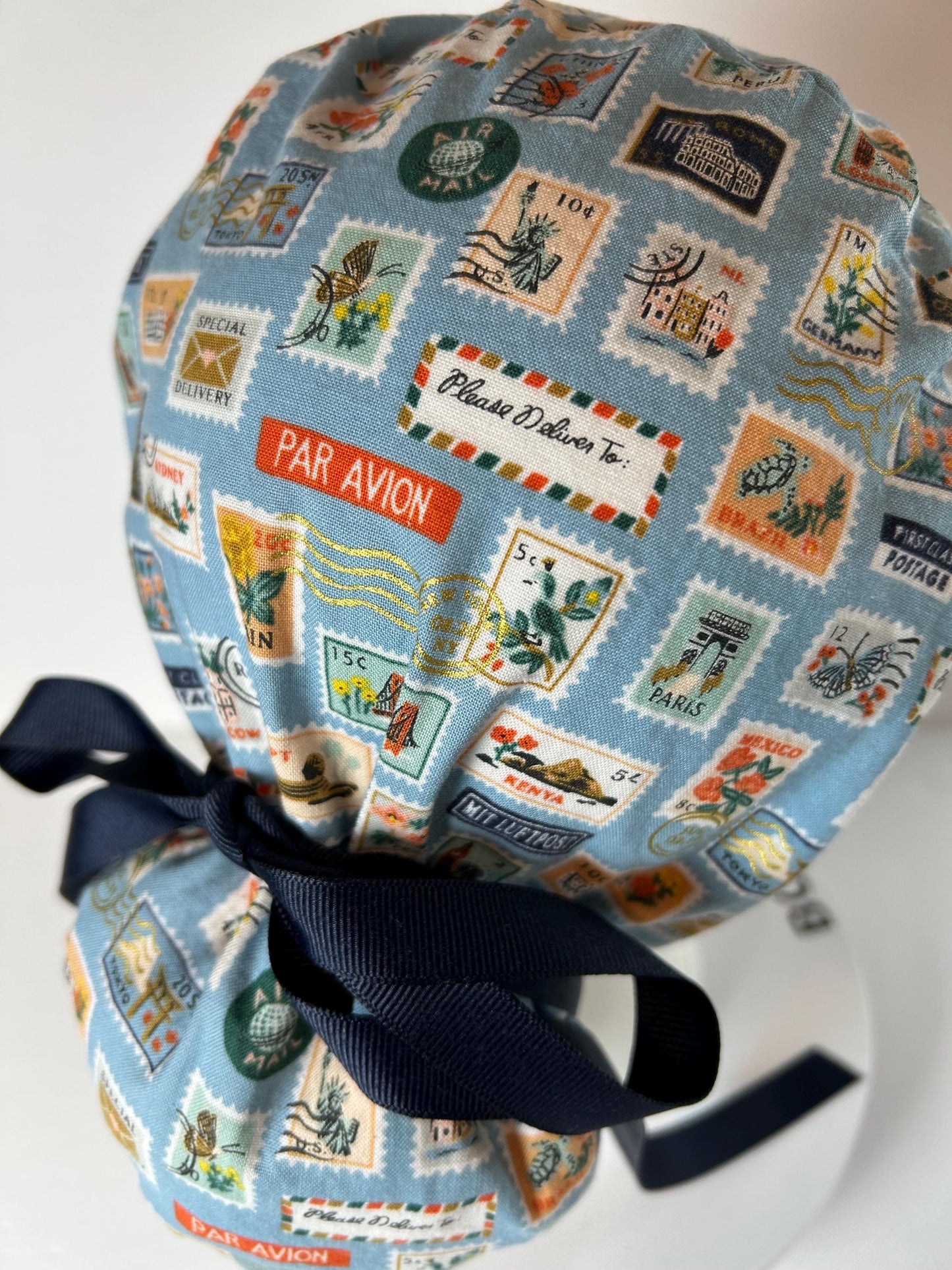 Rifle Paper travel stamp print scrub cap, blue and green travel stamps ponytail scrub hat, Bonnet Head Designs