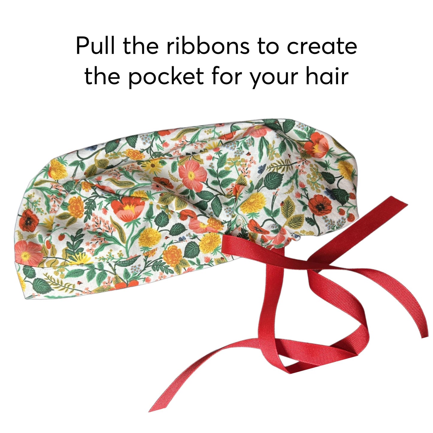 A colorful patterned hair accessory, possibly a hair band or headband, with a red ribbon tied around it.