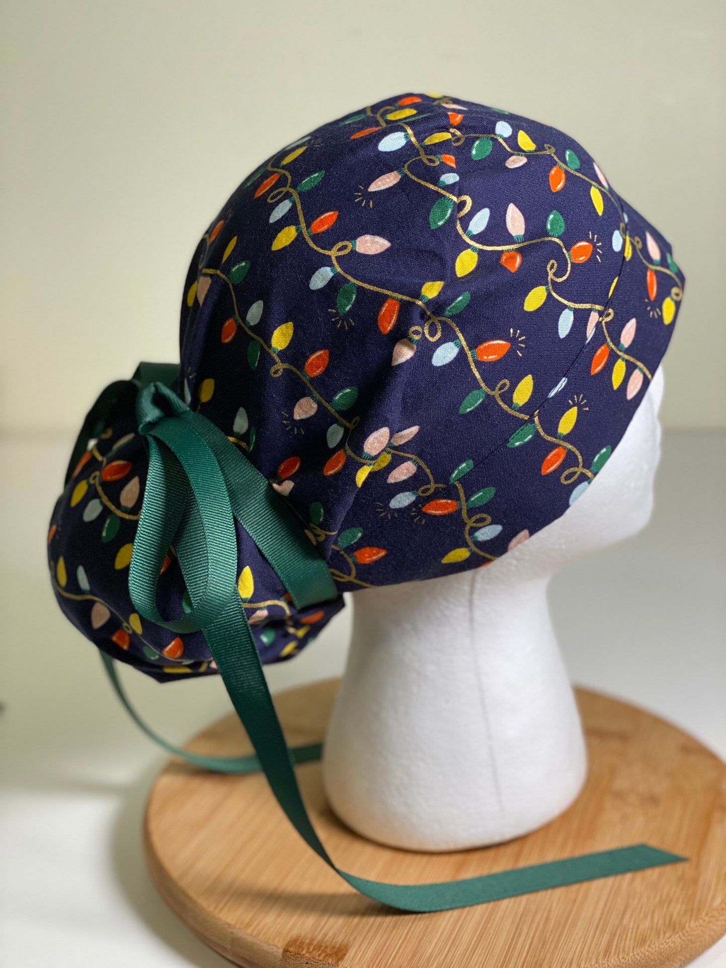 Navy holiday lights scrub cap, Rifle Paper Co holiday fabric scrub hat, women’s Christmas lights scrub hat, Bonnet Head Designs