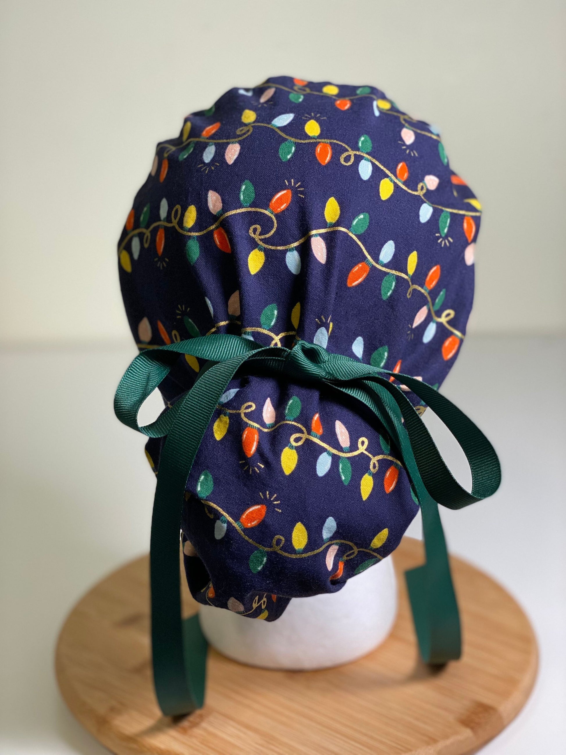 Navy holiday lights scrub cap, Rifle Paper Co holiday fabric scrub hat, women’s Christmas lights scrub hat, Bonnet Head Designs