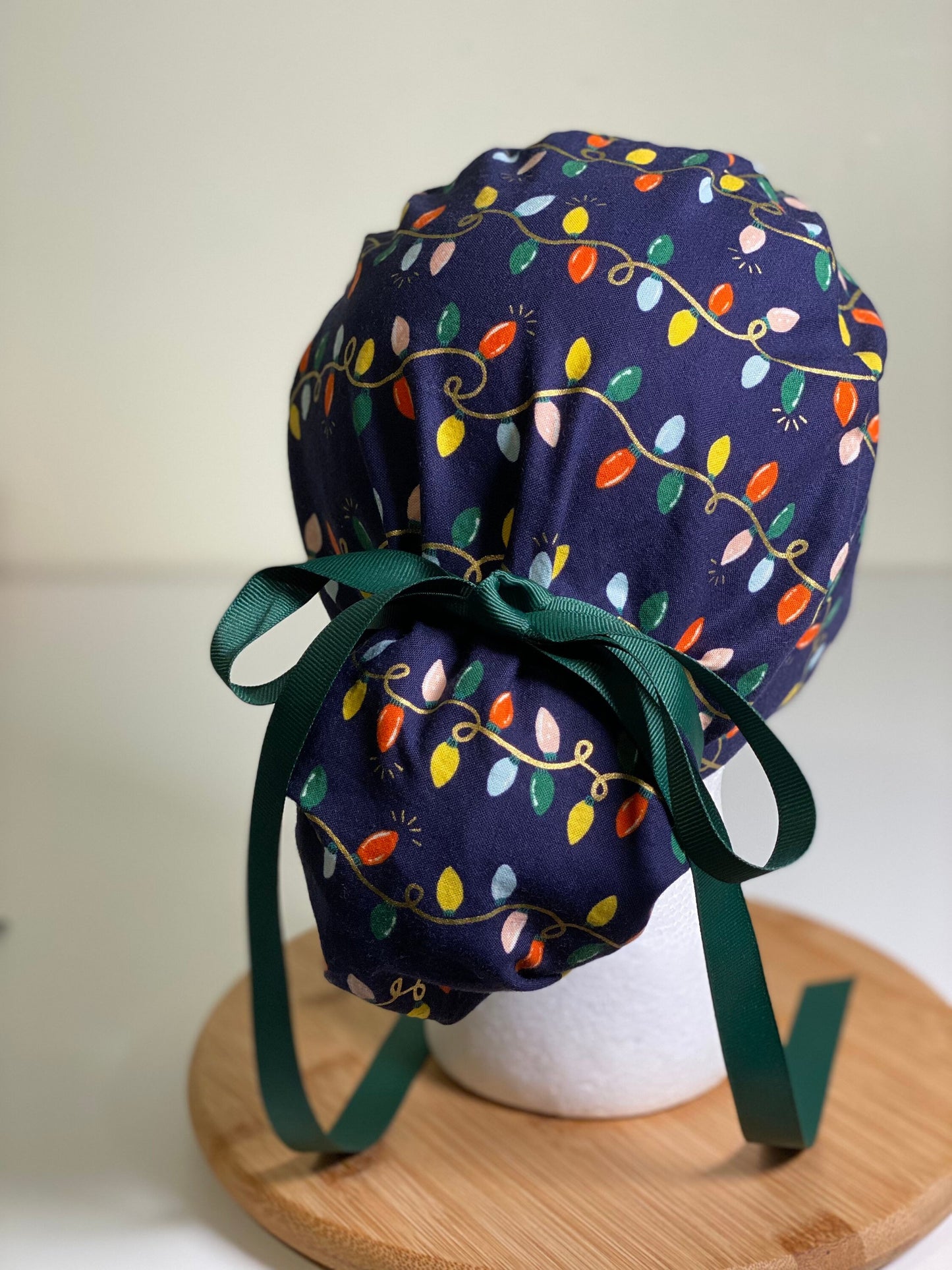 Navy holiday lights scrub cap, Rifle Paper Co holiday fabric scrub hat, women’s Christmas lights scrub hat, Bonnet Head Designs