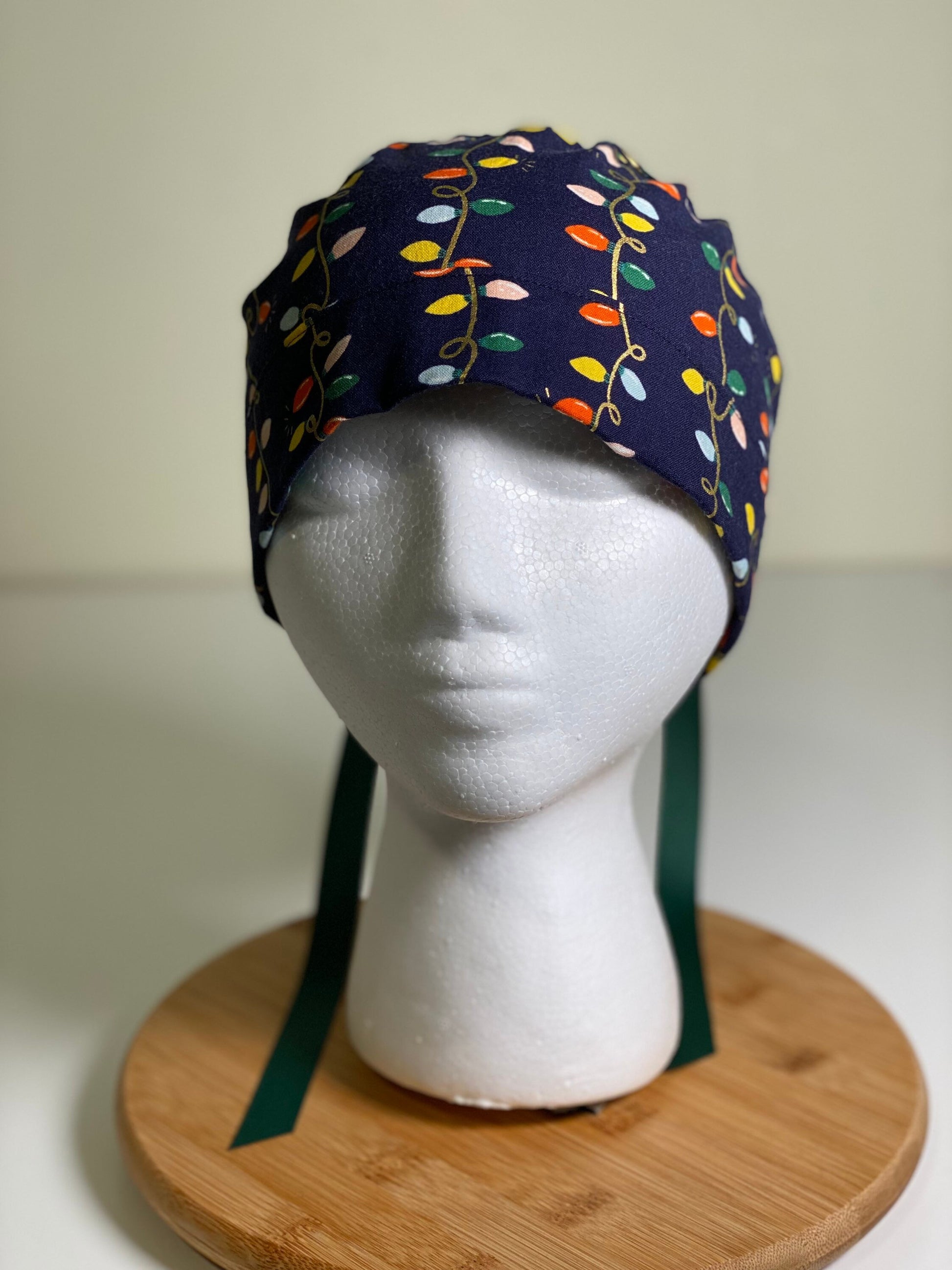 Navy holiday lights scrub cap, Rifle Paper Co holiday fabric scrub hat, women’s Christmas lights scrub hat, Bonnet Head Designs