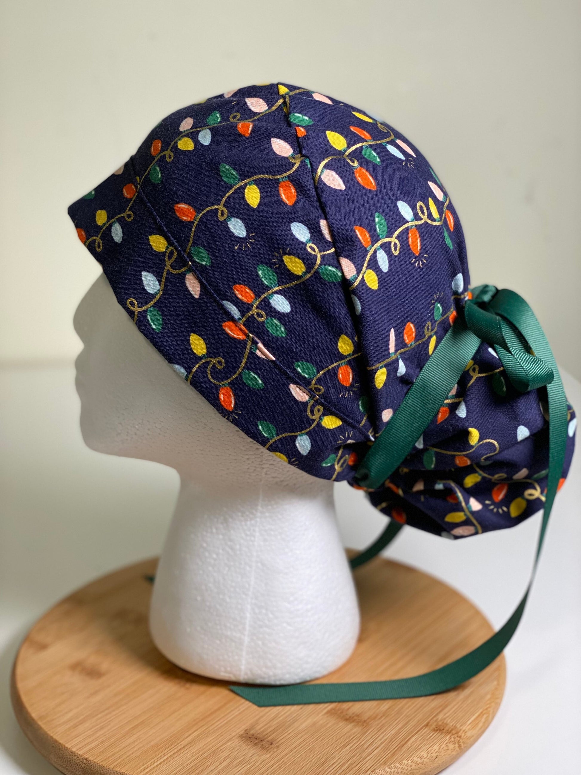 Navy holiday lights scrub cap, Rifle Paper Co holiday fabric scrub hat, women’s Christmas lights scrub hat, Bonnet Head Designs