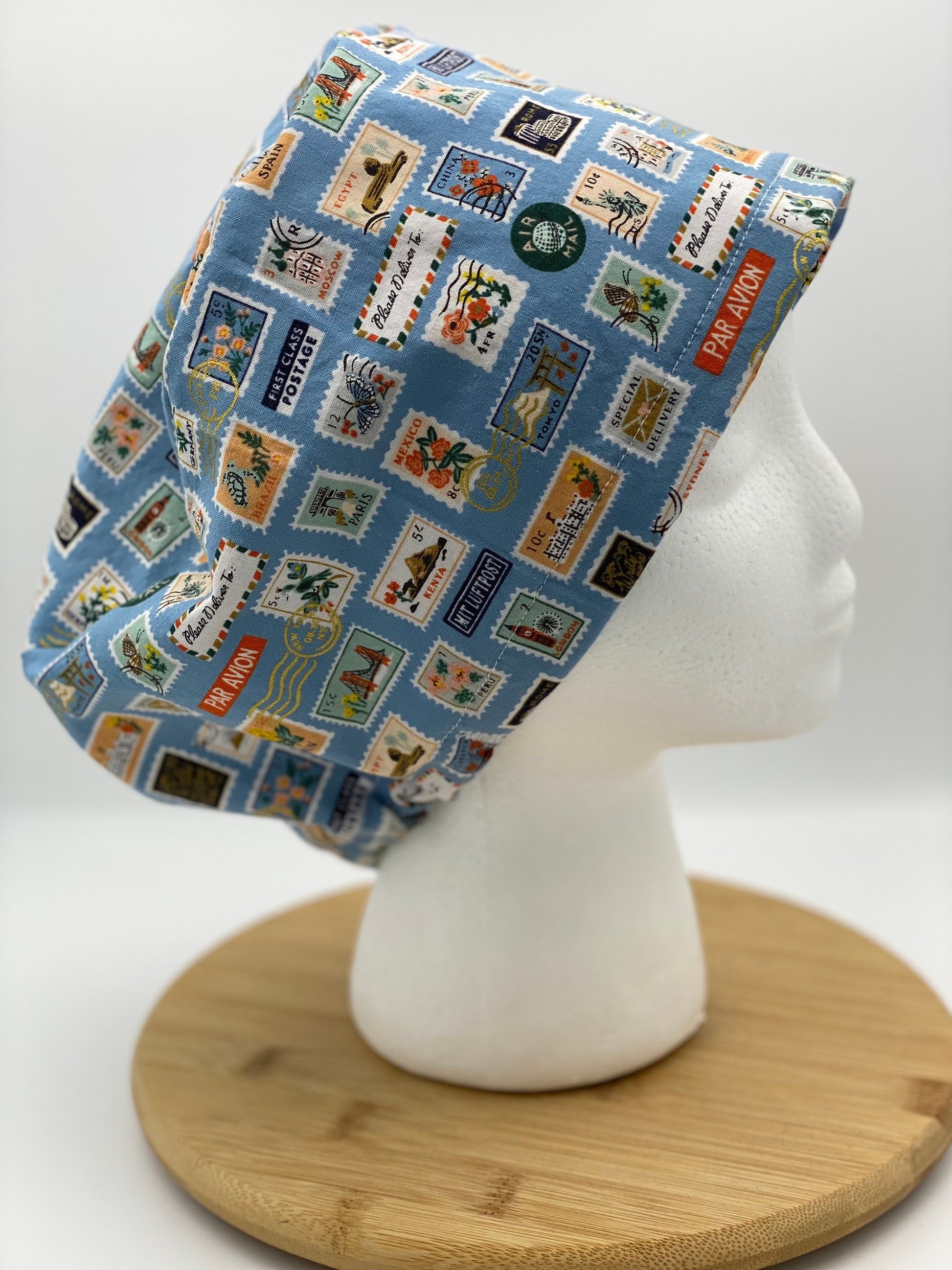 Blue postage stamp euro scrub cap, Rifle Paper Bon Voyage print women’s euro scrub cap, scrub cap stamps, Bonnet Head Designs
