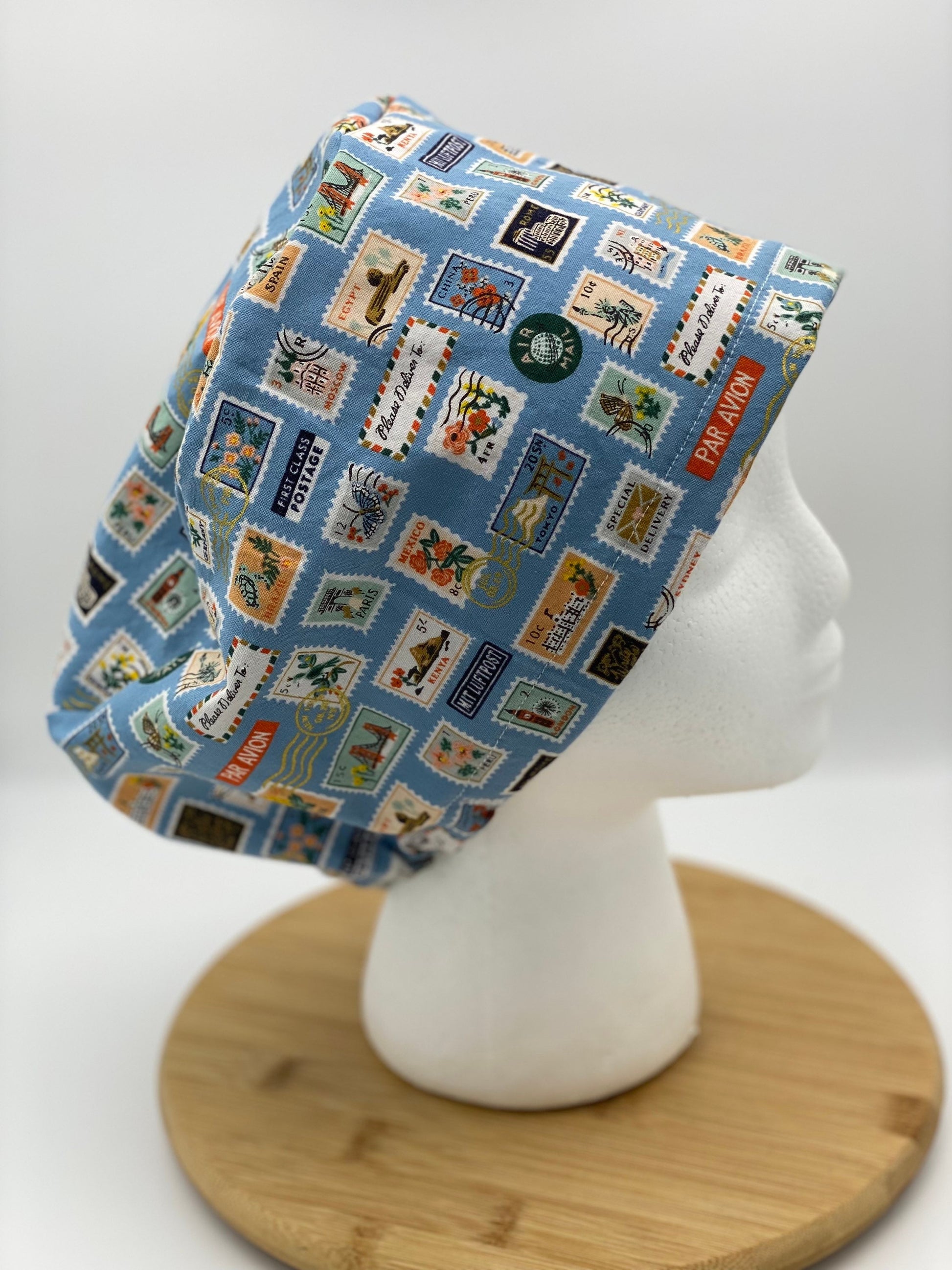 Blue postage stamp euro scrub cap, Rifle Paper Bon Voyage print women’s euro scrub cap, scrub cap stamps, Bonnet Head Designs