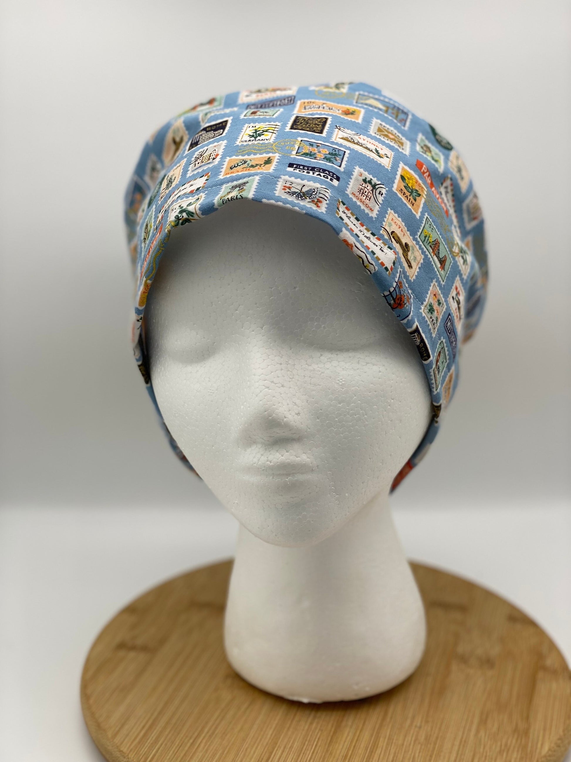 Blue postage stamp euro scrub cap, Rifle Paper Bon Voyage print women’s euro scrub cap, scrub cap stamps, Bonnet Head Designs