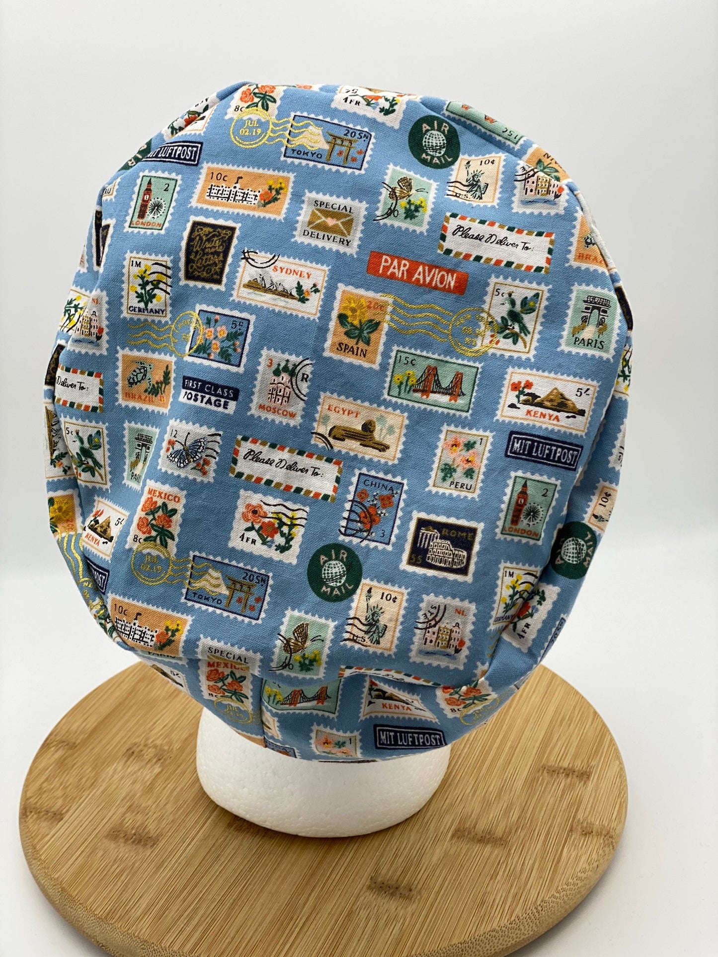 Blue postage stamp euro scrub cap, Rifle Paper Bon Voyage print women’s euro scrub cap, scrub cap stamps, Bonnet Head Designs