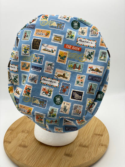Blue postage stamp euro scrub cap, Rifle Paper Bon Voyage print women’s euro scrub cap, scrub cap stamps, Bonnet Head Designs