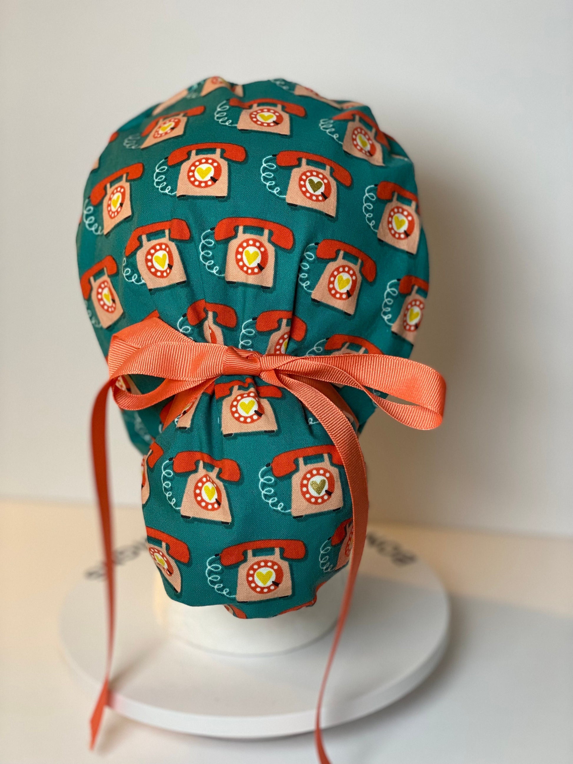 Telephone women’s scrub cap, teal and coral telephone ponytail scrub hat