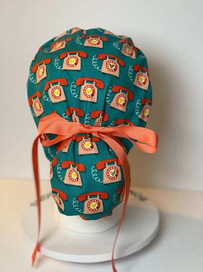 Telephone women’s scrub cap, teal and coral telephone ponytail scrub hat