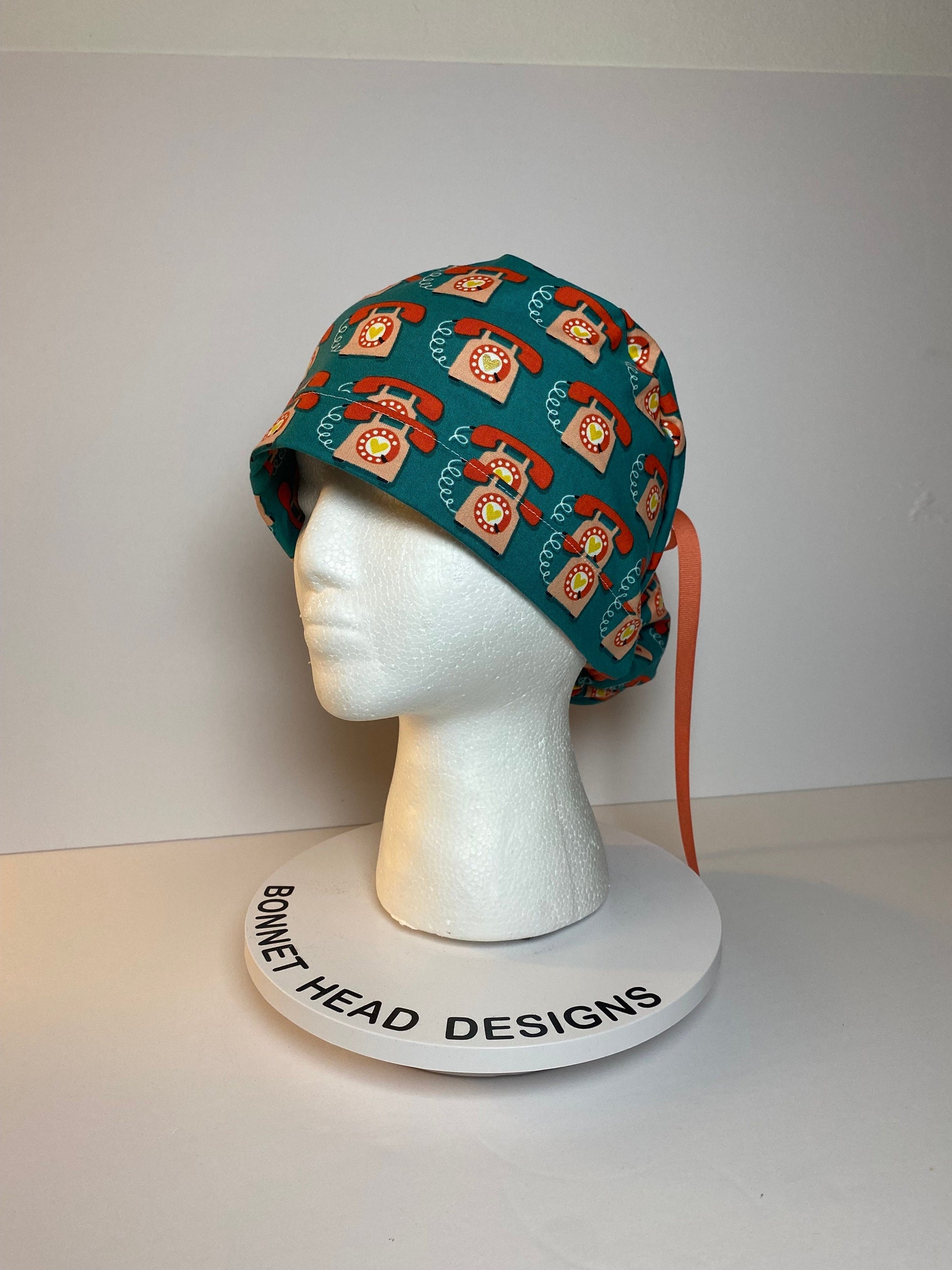 Telephone women’s scrub cap, teal and coral telephone ponytail scrub hat