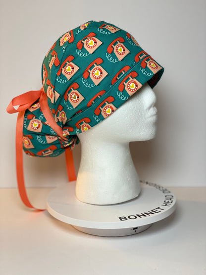 Telephone women’s scrub cap, teal and coral telephone ponytail scrub hat