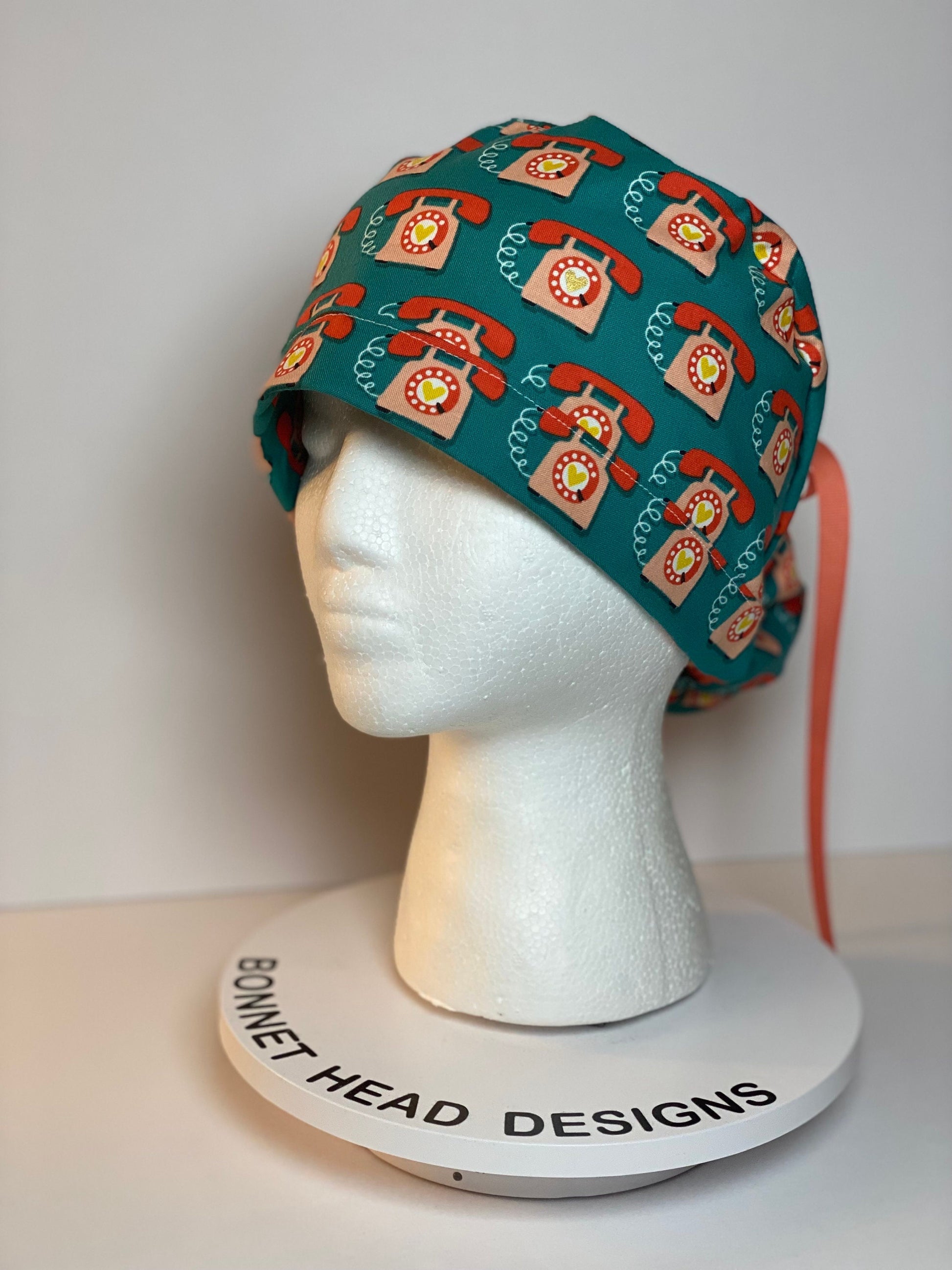 Telephone women’s scrub cap, teal and coral telephone ponytail scrub hat