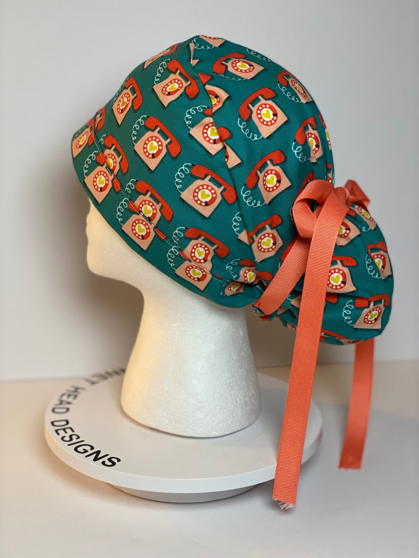 Telephone women’s scrub cap, teal and coral telephone ponytail scrub hat