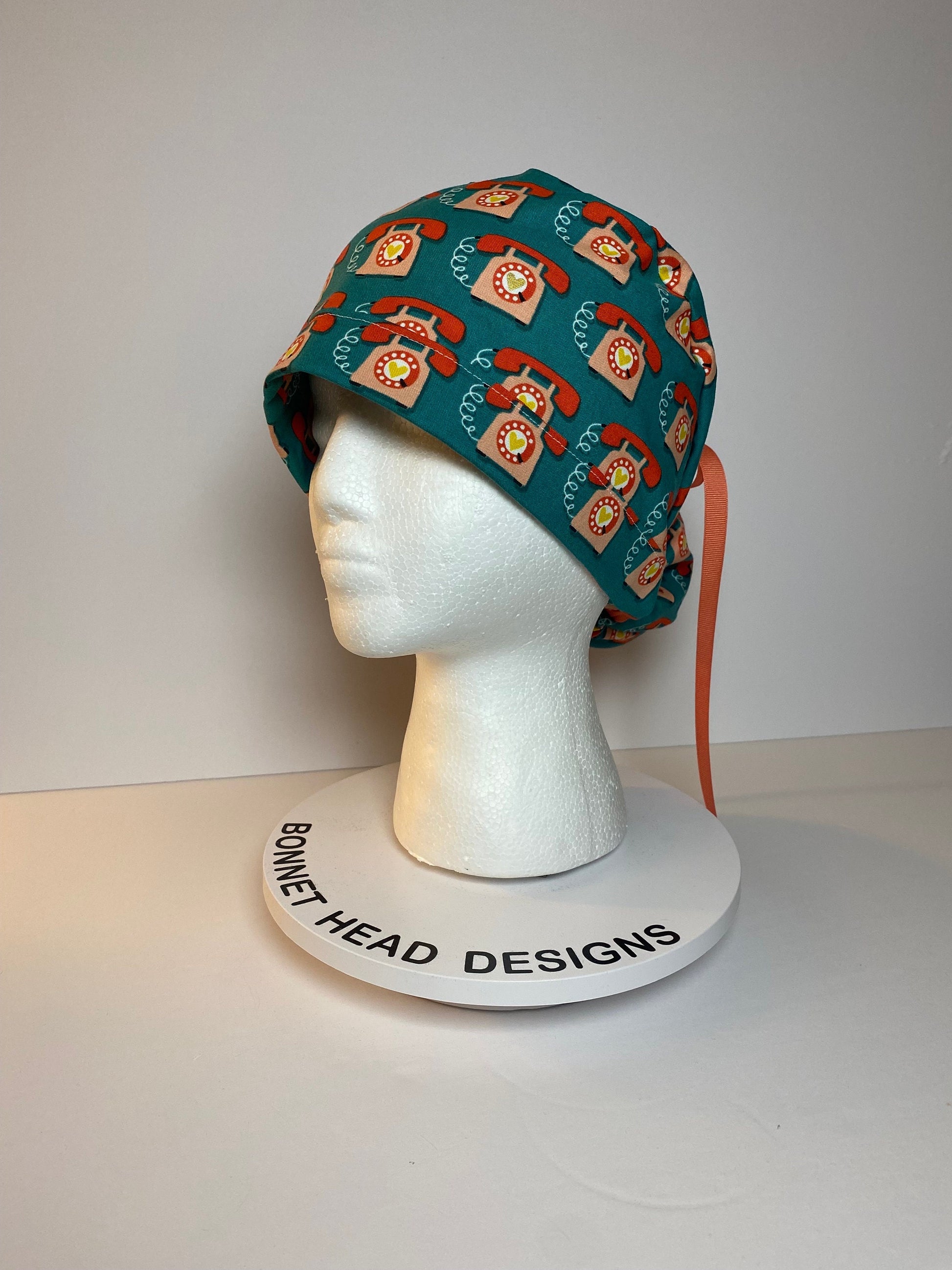 Telephone women’s scrub cap, teal and coral telephone ponytail scrub hat