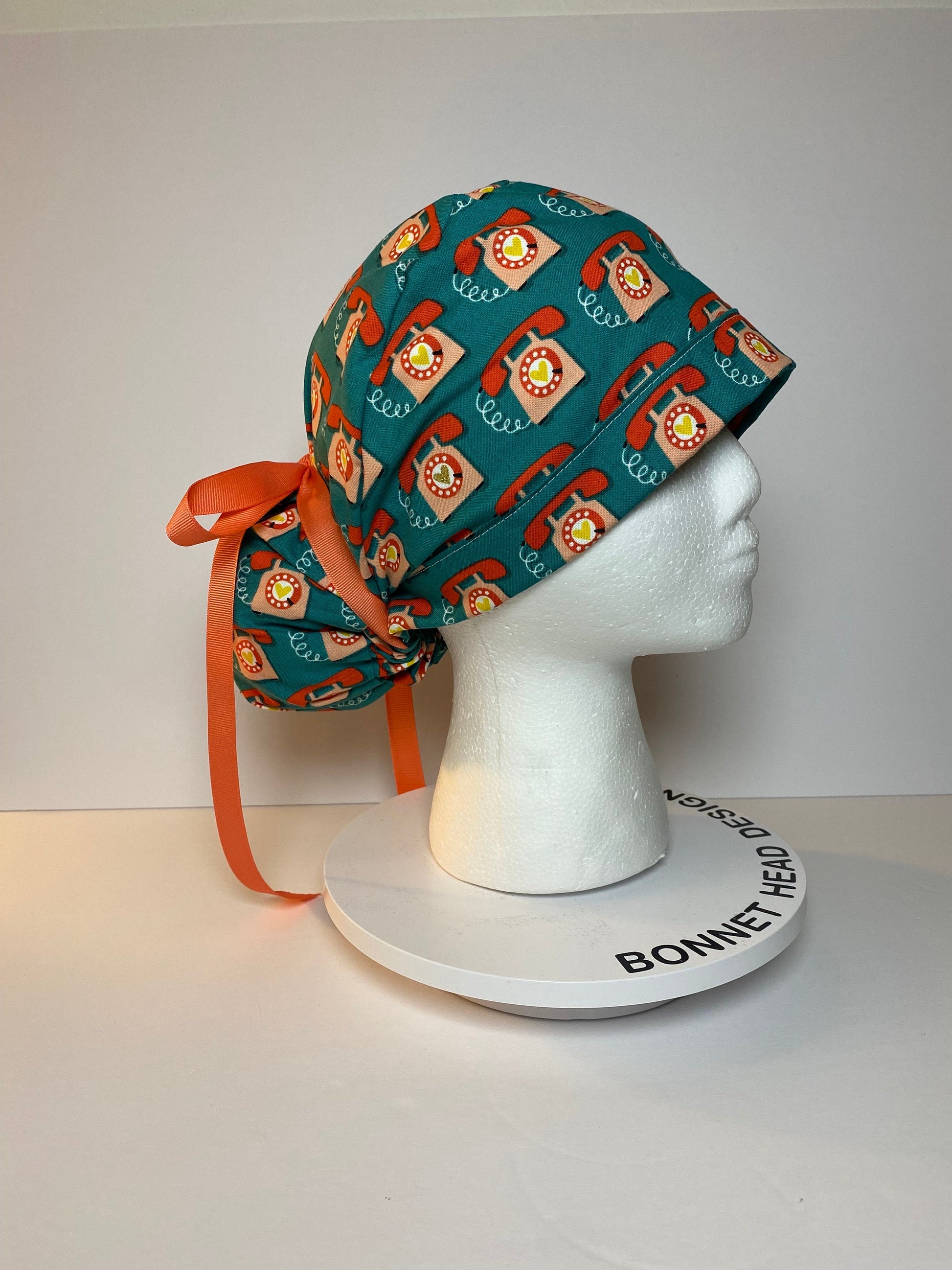 Telephone women’s scrub cap, teal and coral telephone ponytail scrub hat