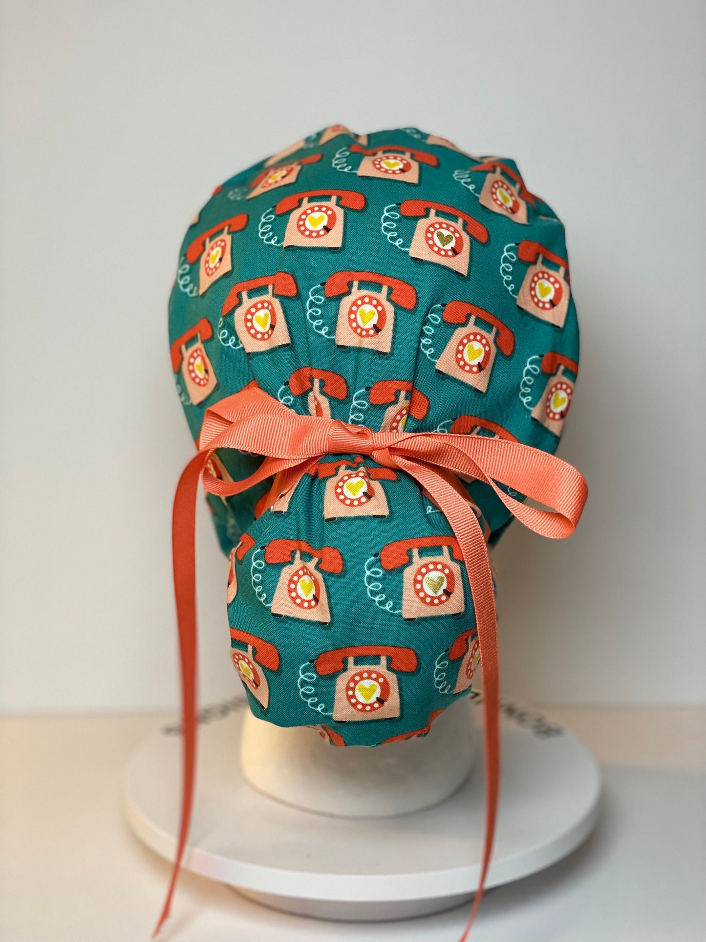 Telephone women’s scrub cap, teal and coral telephone ponytail scrub hat