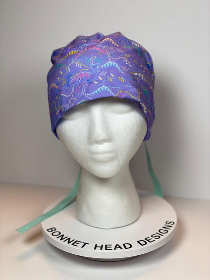 Purple Dinosaur print scrub cap, ponytail scrub hat girly dinosaurs, Bonnet Head Designs