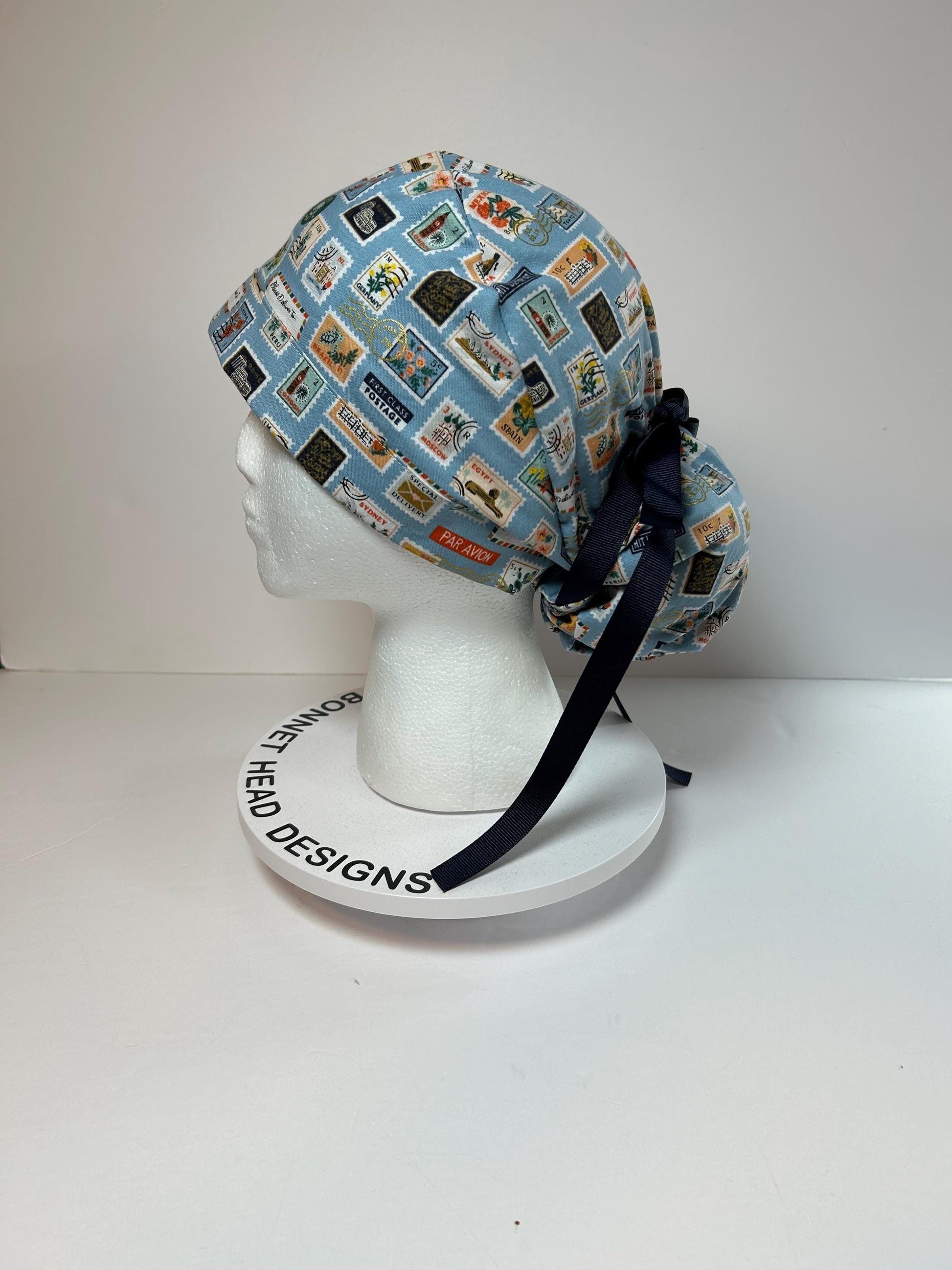 Rifle Paper travel stamp print scrub cap, blue and green travel stamps ponytail scrub hat, Bonnet Head Designs