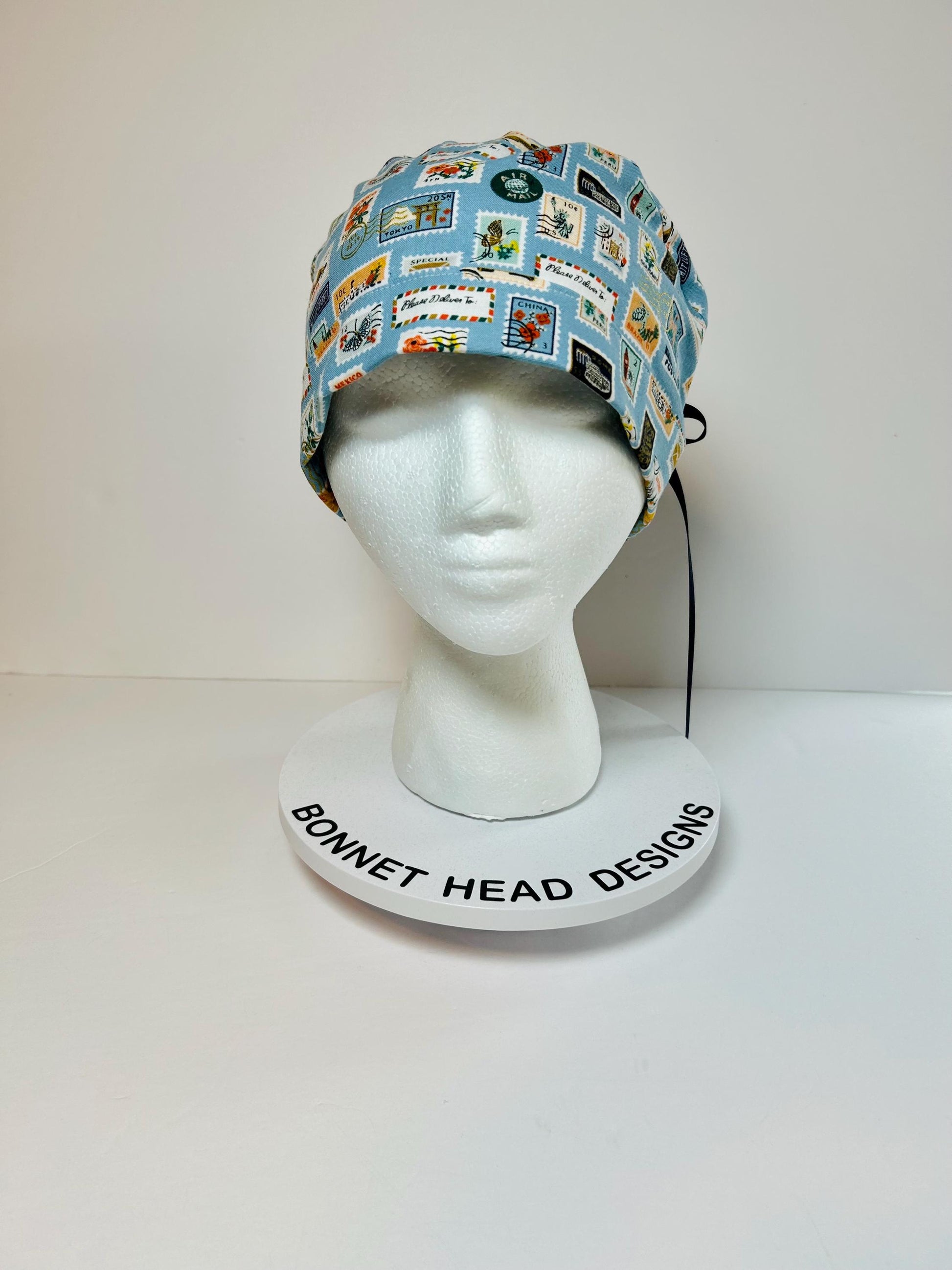 Rifle Paper travel stamp print scrub cap, blue and green travel stamps ponytail scrub hat, Bonnet Head Designs