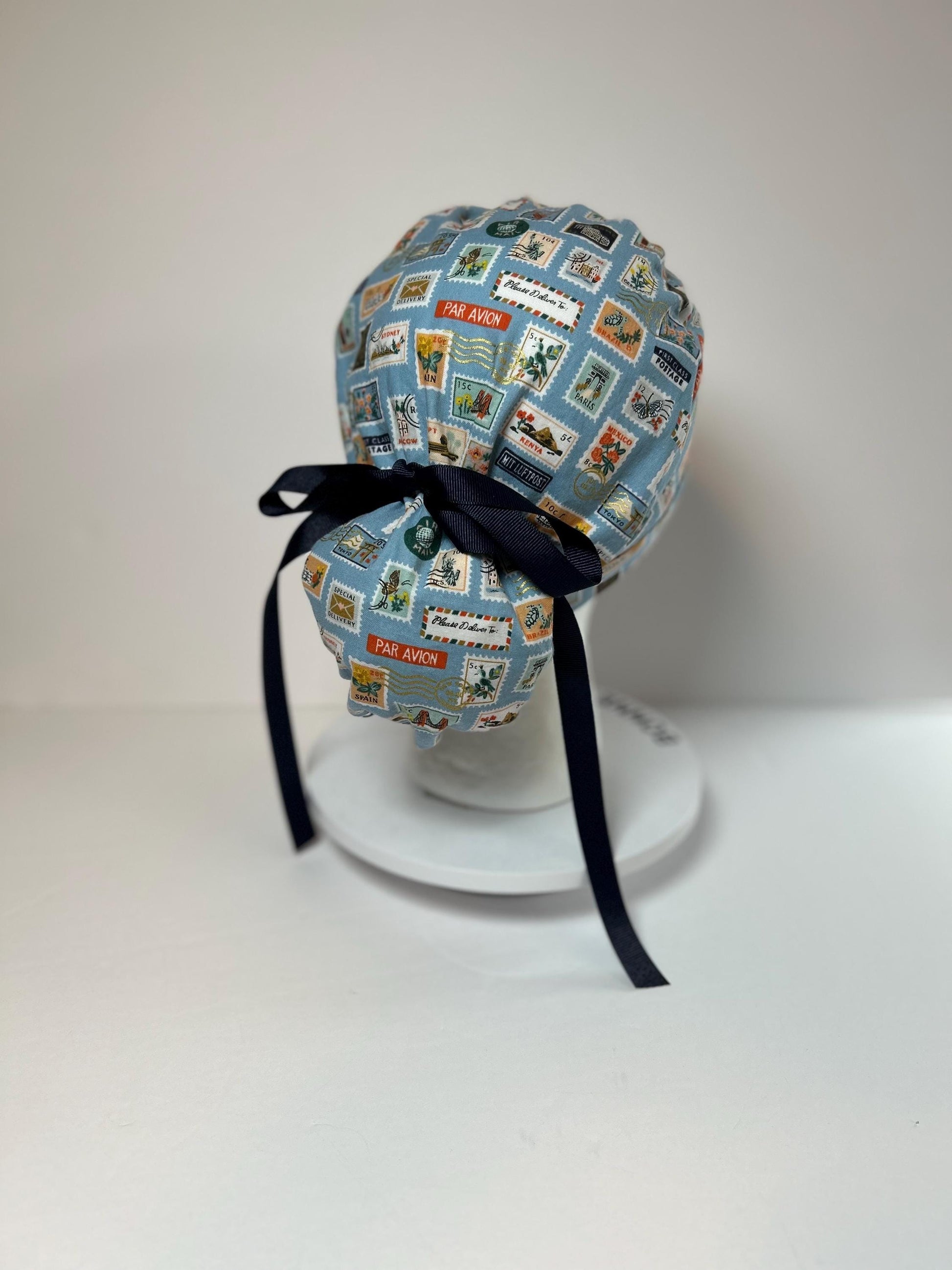 Rifle Paper travel stamp print scrub cap, blue and green travel stamps ponytail scrub hat, Bonnet Head Designs