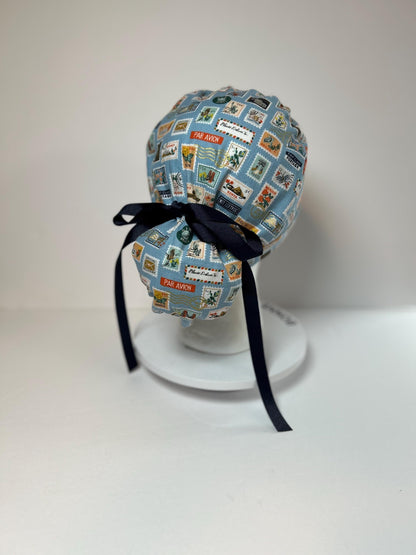 Rifle Paper travel stamp print scrub cap, blue and green travel stamps ponytail scrub hat, Bonnet Head Designs