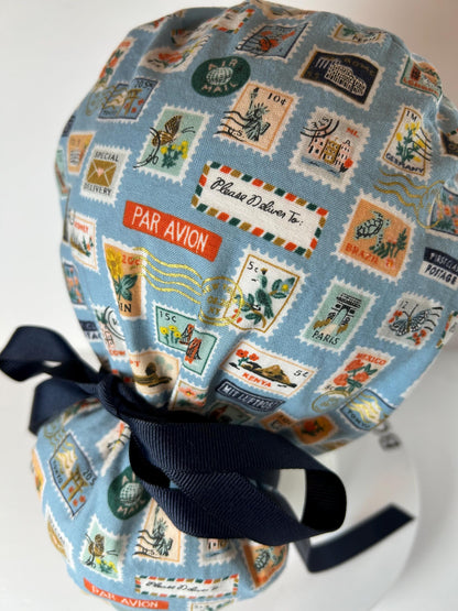 Rifle Paper travel stamp print scrub cap, blue and green travel stamps ponytail scrub hat, Bonnet Head Designs
