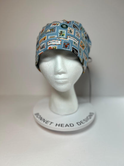 Rifle Paper travel stamp print scrub cap, blue and green travel stamps ponytail scrub hat, Bonnet Head Designs