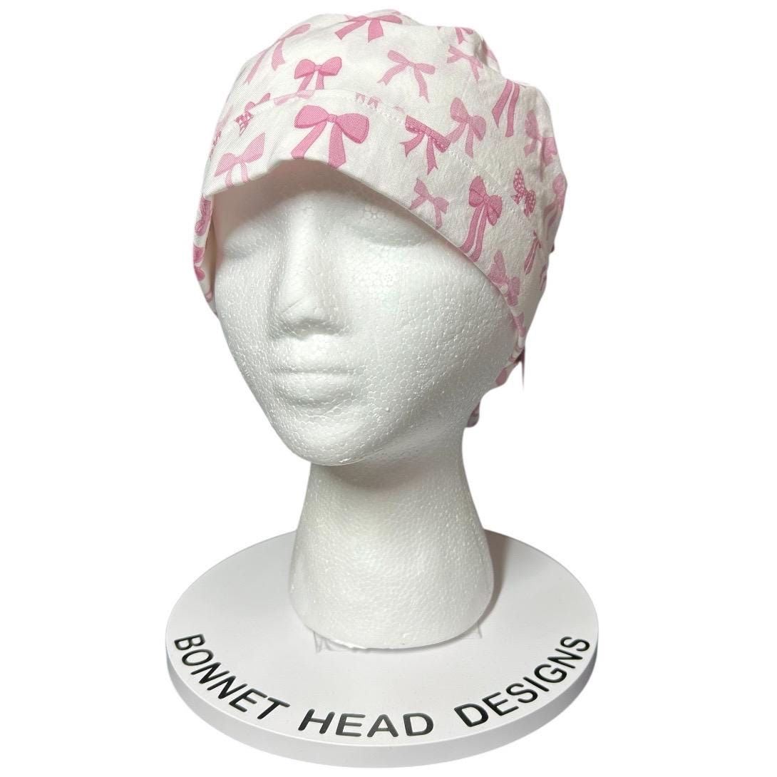 Women’s pink tied with a bow print ponytail scrub cap, pink coquette scrub hat with cinch ties