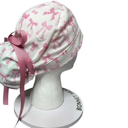 Women’s pink tied with a bow print ponytail scrub cap, pink coquette scrub hat with cinch ties