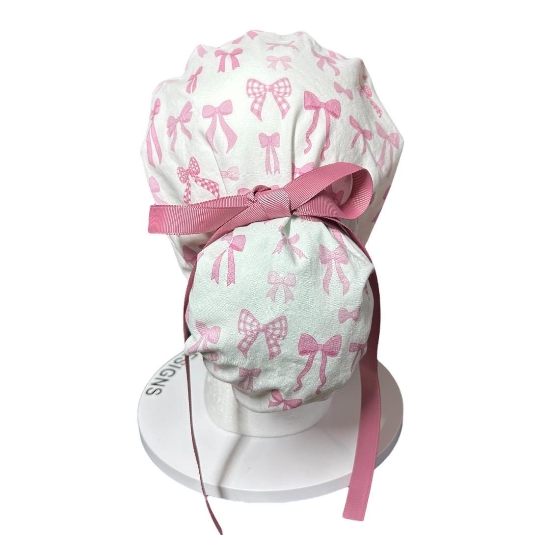 Women’s pink tied with a bow print ponytail scrub cap, pink coquette scrub hat with cinch ties