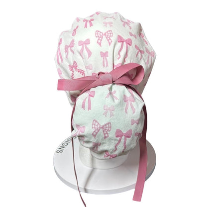Women’s pink tied with a bow print ponytail scrub cap, pink coquette scrub hat with cinch ties
