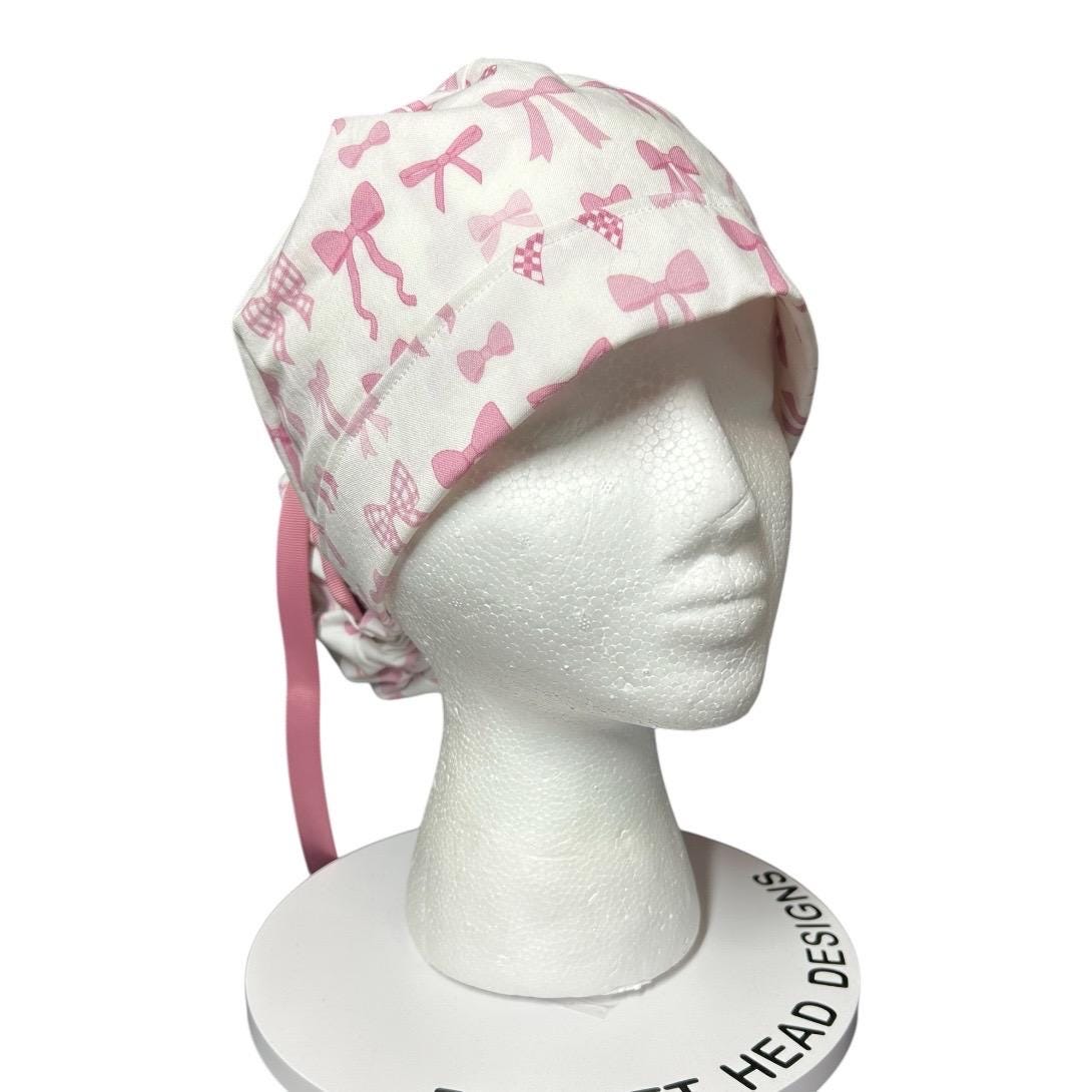 Women’s pink tied with a bow print ponytail scrub cap, pink coquette scrub hat with cinch ties