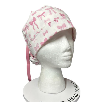 Women’s pink tied with a bow print ponytail scrub cap, pink coquette scrub hat with cinch ties
