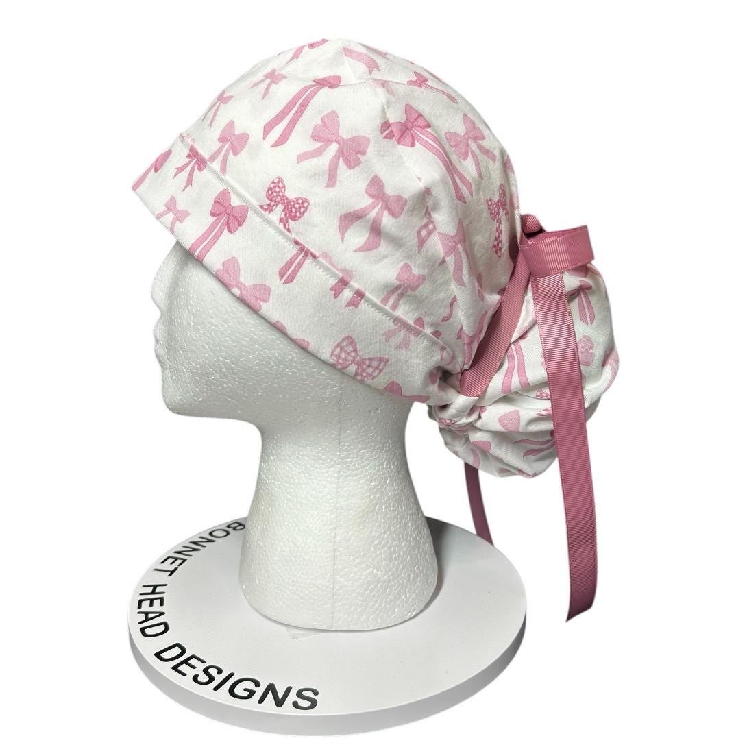 Women’s pink tied with a bow print ponytail scrub cap, pink coquette scrub hat with cinch ties
