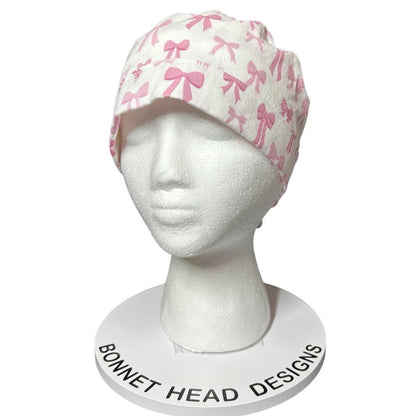 Women’s pink tied with a bow print ponytail scrub cap, pink coquette scrub hat with cinch ties