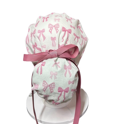 Women’s pink tied with a bow print ponytail scrub cap, pink coquette scrub hat with cinch ties