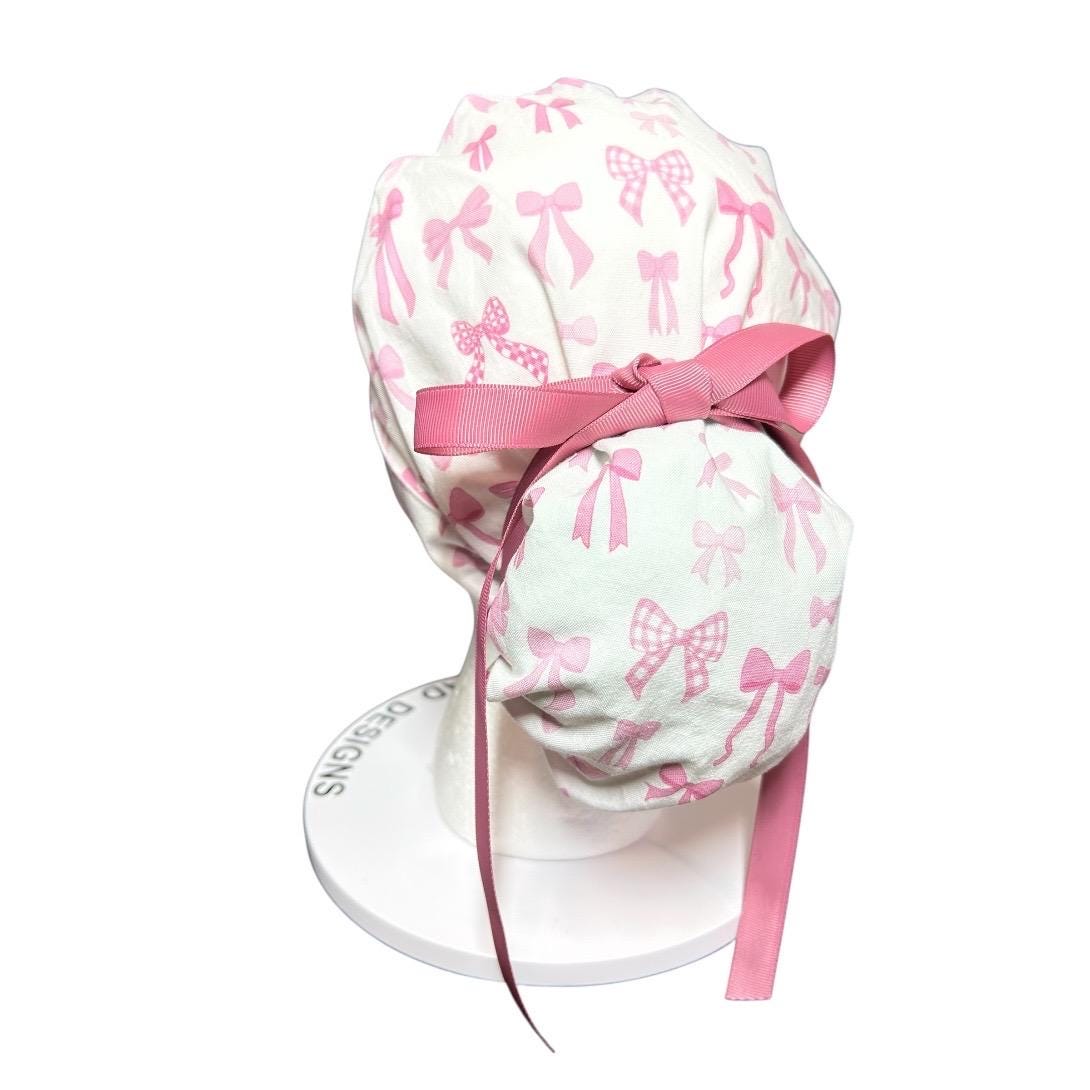 Women’s pink tied with a bow print ponytail scrub cap, pink coquette scrub hat with cinch ties