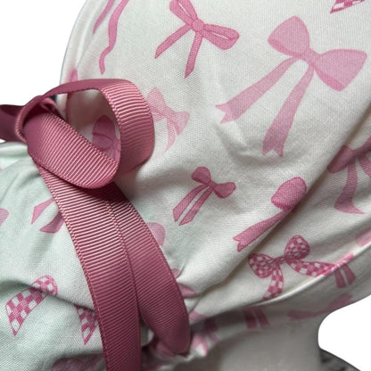 Women’s pink tied with a bow print ponytail scrub cap, pink coquette scrub hat with cinch ties