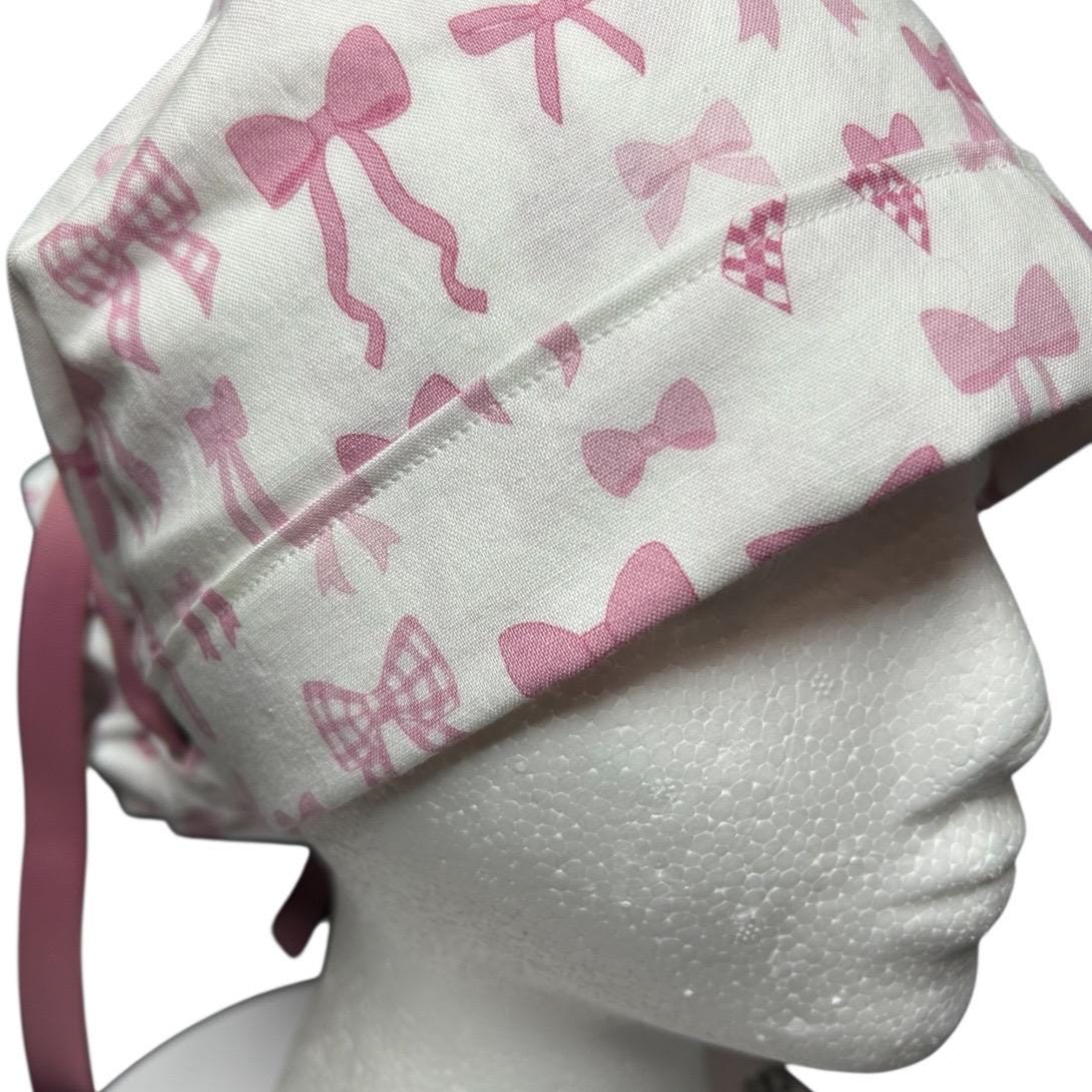 Women’s pink tied with a bow print ponytail scrub cap, pink coquette scrub hat with cinch ties