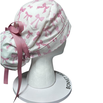 Women’s pink tied with a bow print ponytail scrub cap, pink coquette scrub hat with cinch ties