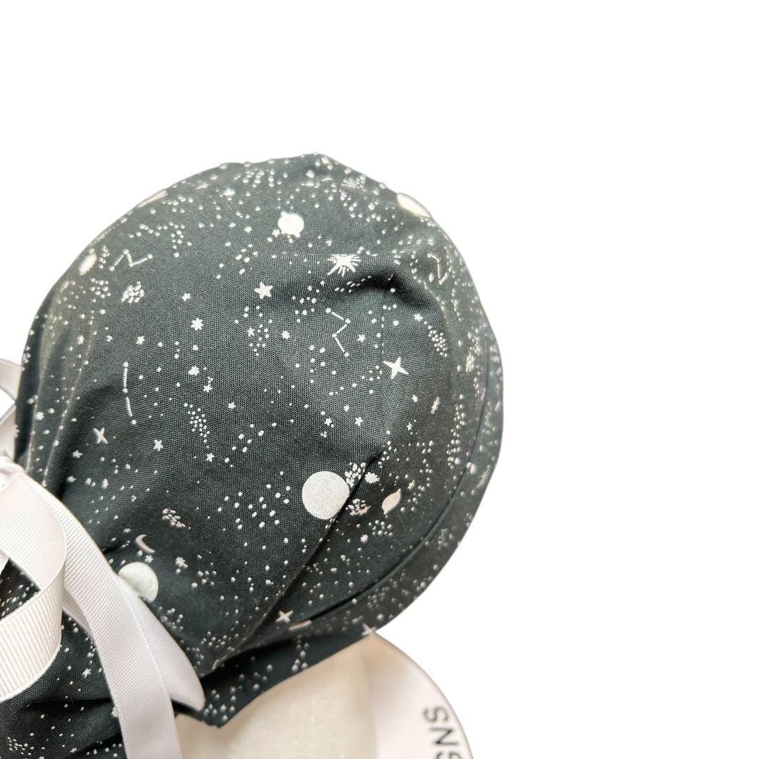 Night sky ponytail scrub hat: Black and white space print fabric with ribbon ties