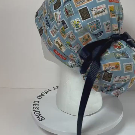Rifle Paper travel stamp print scrub cap, blue and green travel stamps ponytail scrub hat, Bonnet Head Designs