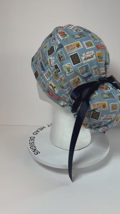 Rifle Paper travel stamp print scrub cap, blue and green travel stamps ponytail scrub hat, Bonnet Head Designs