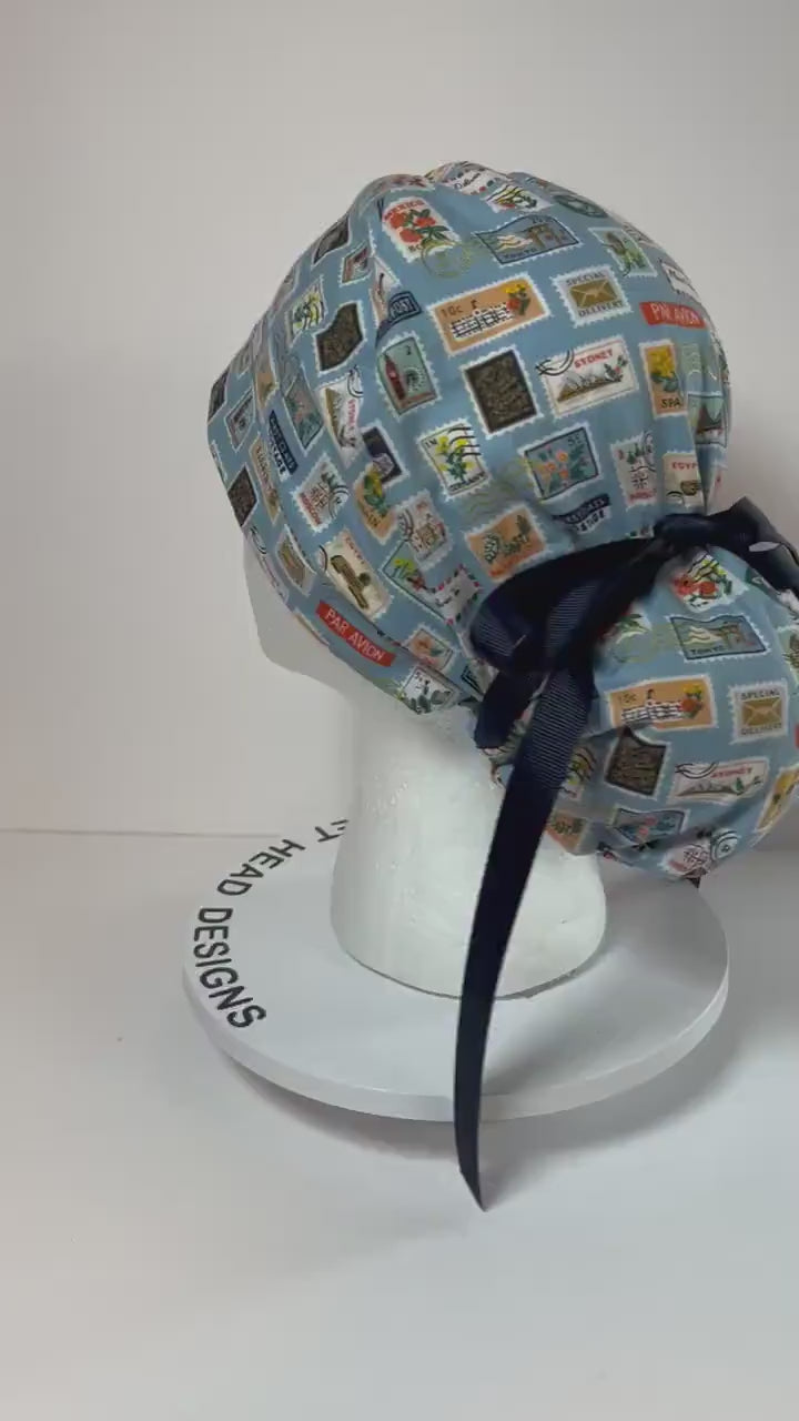 Rifle Paper travel stamp print scrub cap, blue and green travel stamps ponytail scrub hat, Bonnet Head Designs