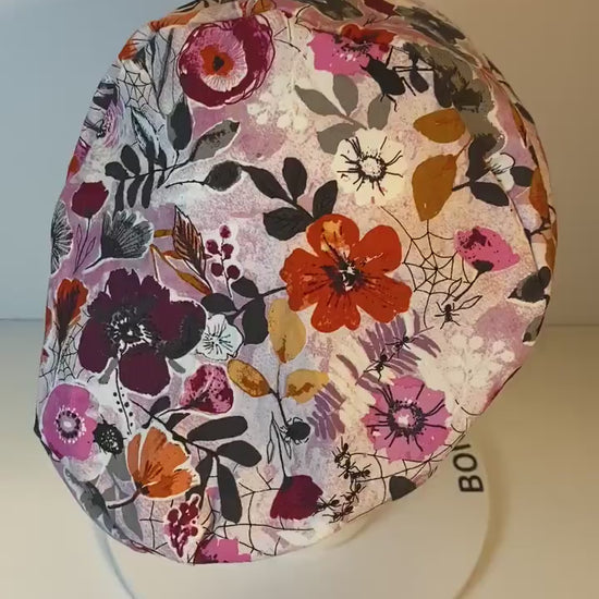 Pink Halloween floral euro scrub hat, women’s eerie Halloween floral euro style scrub cap