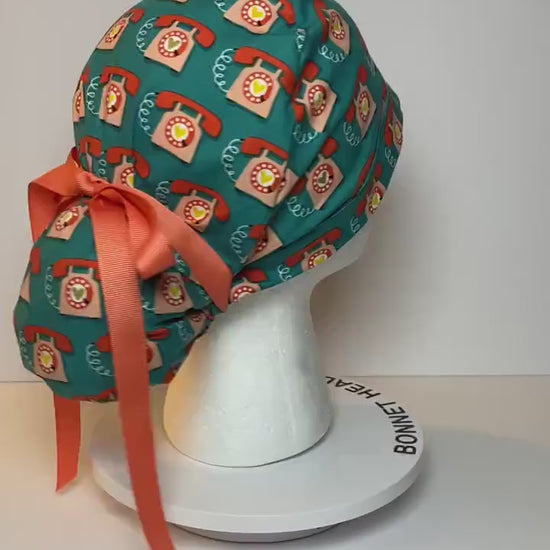 Telephone women’s scrub cap, teal and coral telephone ponytail scrub hat