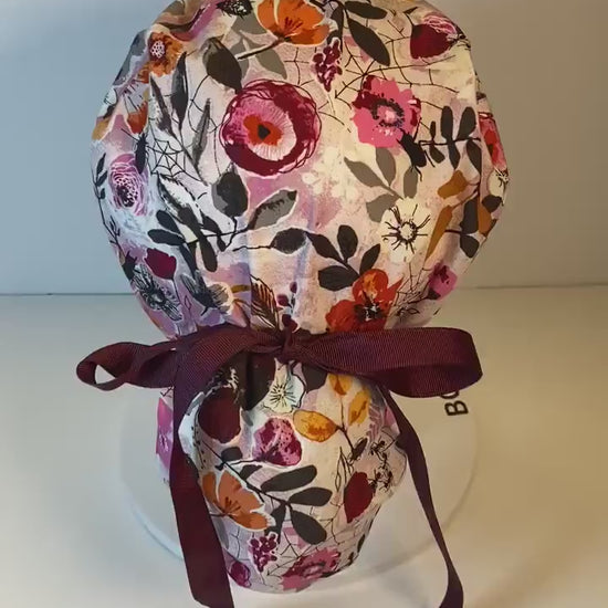 Eerie Halloween pink floral ponytail scrub hat, women’s Halloween floral scrub cap