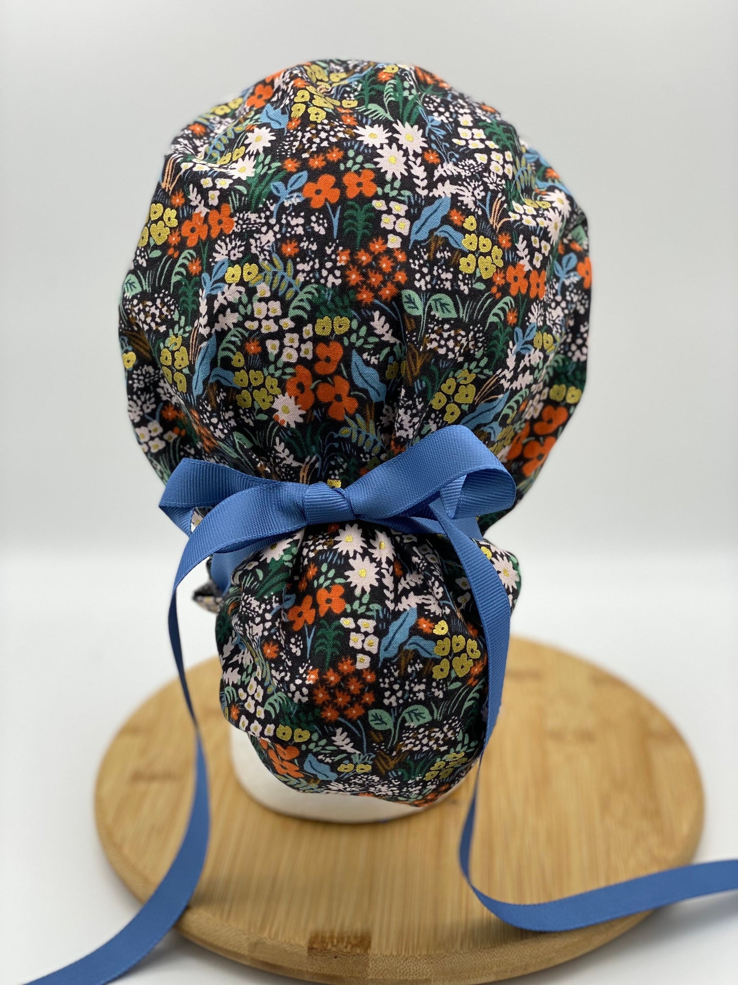 Black meadow floral ponytail scrub cap